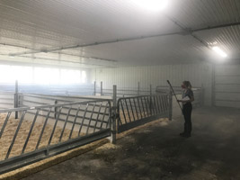 Researcher fogging barn, mist in air