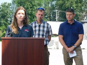 Speakers at podium on farm